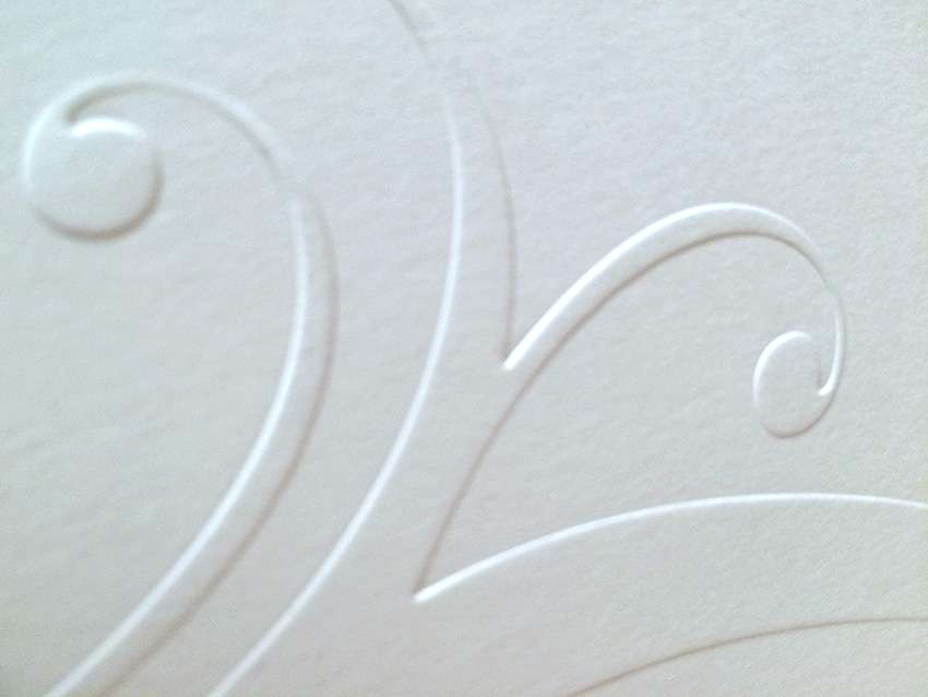 Hochprägung auf Hochzeitspapeterie. Hochzeitskarten aus der Druckerei Werkstatt Dietz München Detailansicht einer blinden Hochprägung auf einer Einladungskarte, sehr edel